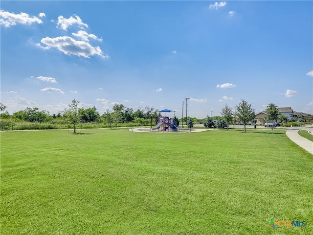 surrounding community with a yard and a playground