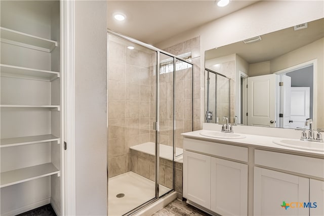 bathroom featuring an enclosed shower and vanity