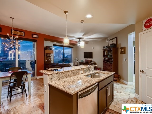 kitchen with sink, ceiling fan with notable chandelier, decorative light fixtures, an island with sink, and dishwasher