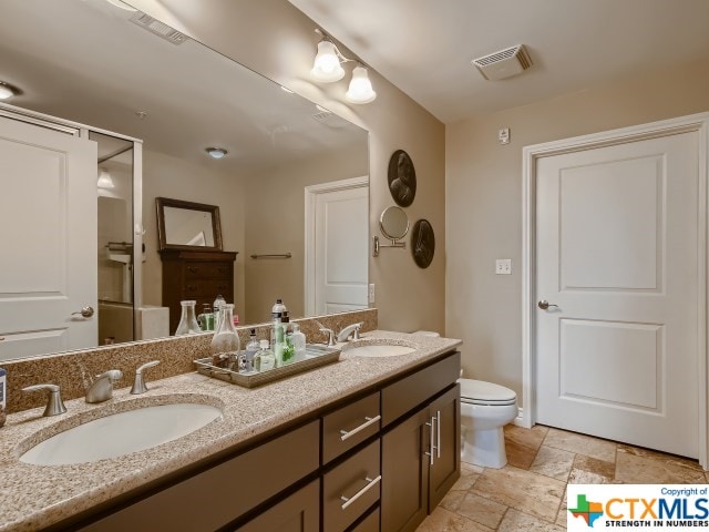 bathroom featuring toilet and vanity