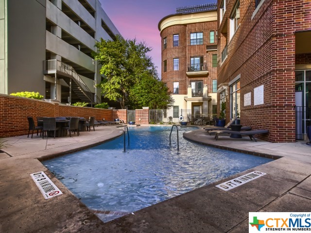 view of pool at dusk