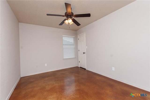 unfurnished room with concrete flooring, baseboards, and a ceiling fan