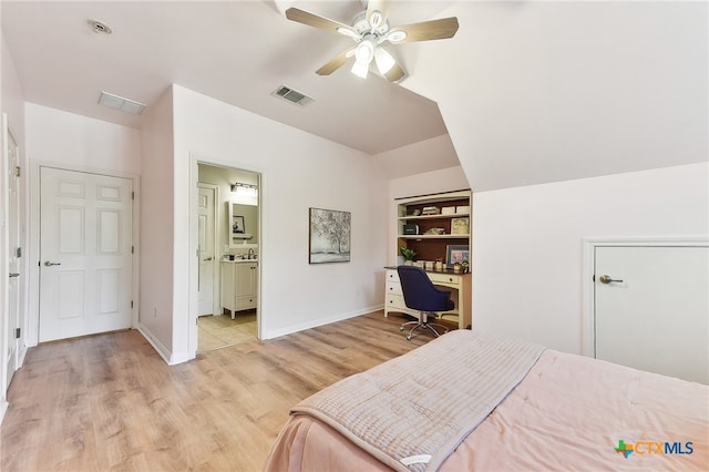 bedroom featuring light wood-type flooring, lofted ceiling, baseboards, a ceiling fan, and an office area