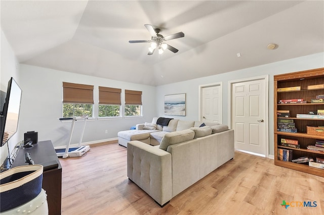 living area with a ceiling fan, light wood finished floors, lofted ceiling, and baseboards
