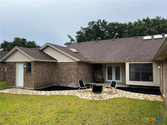 101 Biltmore Dr, Victoria, TX 77904 - rear view of property featuring french doors, a patio, brick siding, and a yard