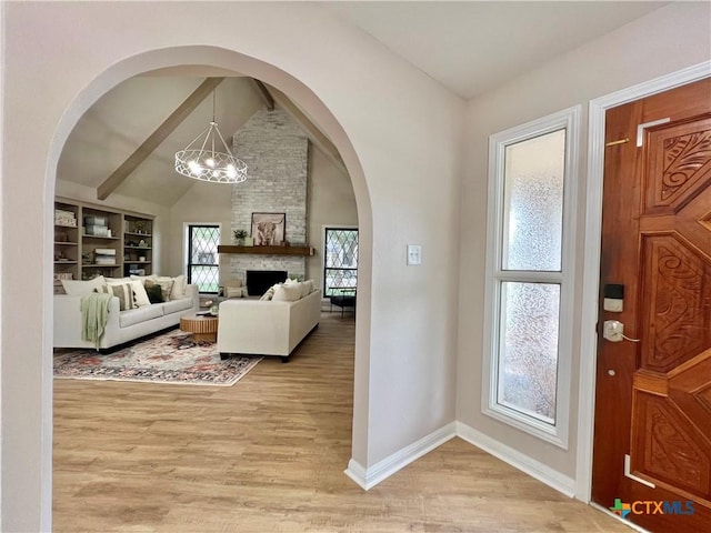 101 Biltmore Dr, Victoria, TX 77904 - foyer entrance with light wood-style floors, a chandelier, and a fireplace
