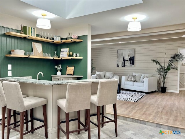 101 Biltmore Dr, Victoria, TX 77904 - bar area with light wood-type flooring and wooden walls