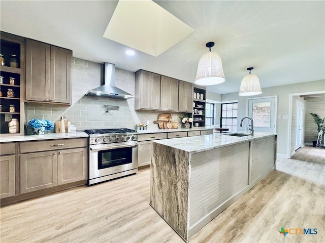 101 Biltmore Dr, Victoria, TX 77904 - kitchen featuring high end range, wall chimney range hood, open shelves, and light wood-style floors