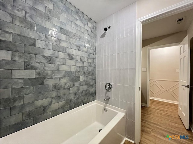 101 Biltmore Dr, Victoria, TX 77904 - bathroom with wood finished floors and bathing tub / shower combination