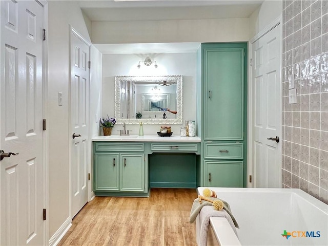 101 Biltmore Dr, Victoria, TX 77904 - bathroom with vanity, a bath, and wood finished floors