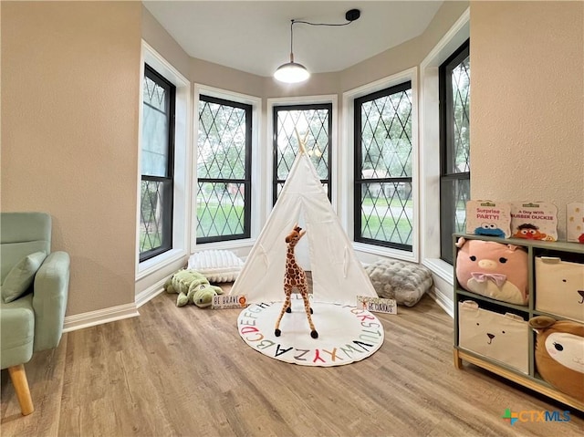 101 Biltmore Dr, Victoria, TX 77904 - rec room with healthy amount of natural light, wood finished floors, and a textured wall