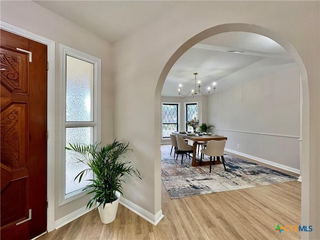 101 Biltmore Dr, Victoria, TX 77904 - entrance foyer with arched walkways, wood finished floors, and a chandelier