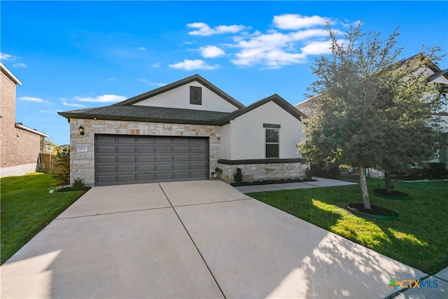 view of front of property with a garage and a front lawn