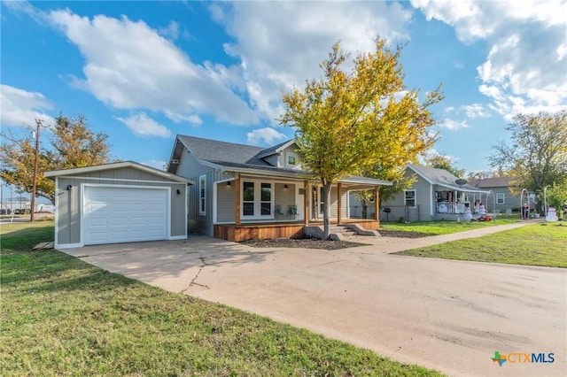 view of front of house featuring a porch, a garage, and a front lawn