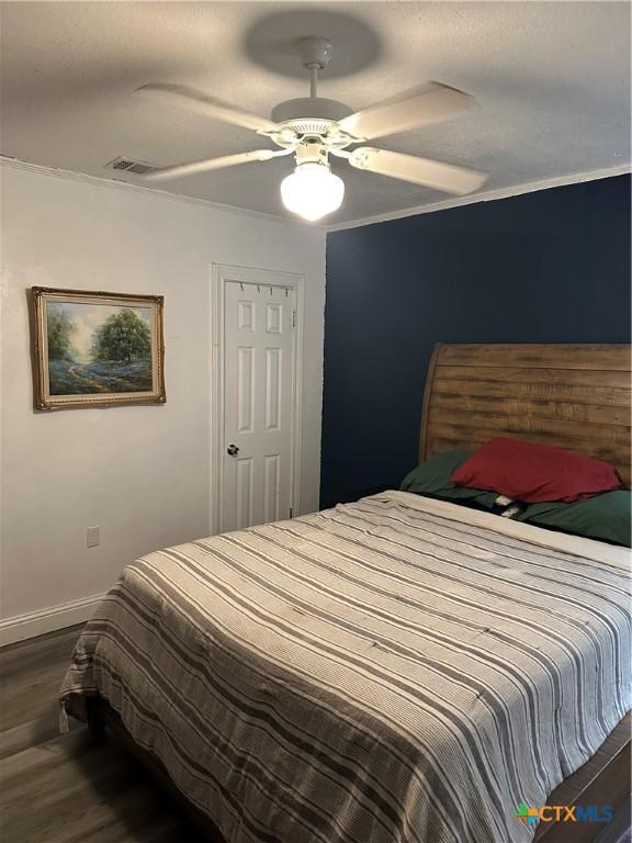 bedroom featuring ceiling fan and dark hardwood / wood-style floors