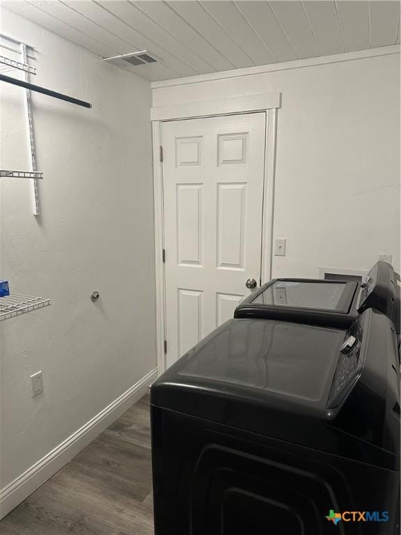 clothes washing area with wooden ceiling, separate washer and dryer, and hardwood / wood-style floors