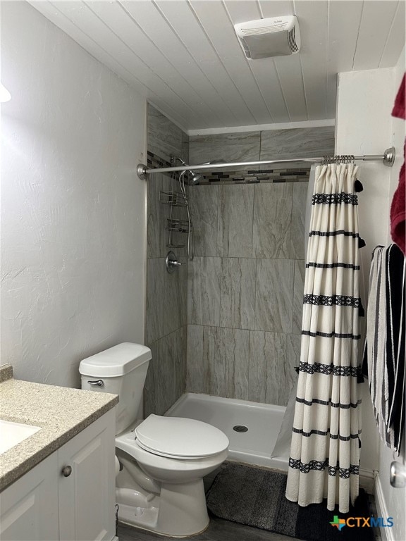 bathroom with toilet, vanity, and a shower with shower curtain