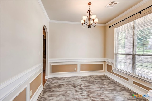 2508 Mugho Dr, Harker Heights, TX 76548 - unfurnished room featuring crown molding, a chandelier, arched walkways, wood finished floors, and wainscoting