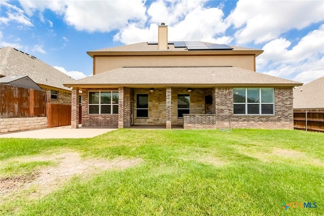 2508 Mugho Dr, Harker Heights, TX 76548 - rear view of house with ceiling fan, a patio, a chimney, roof mounted solar panels, and a fenced backyard