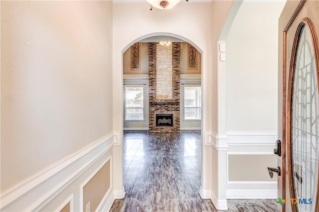2508 Mugho Dr, Harker Heights, TX 76548 - entryway with arched walkways, a fireplace, and wood finished floors