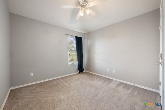 empty room featuring light colored carpet and ceiling fan