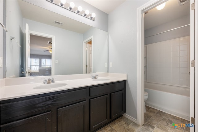 full bathroom featuring vanity, toilet, ceiling fan, and  shower combination