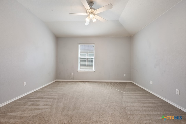 carpeted empty room with ceiling fan and vaulted ceiling