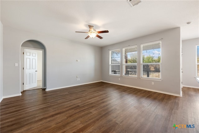 unfurnished room with ceiling fan and dark wood-type flooring