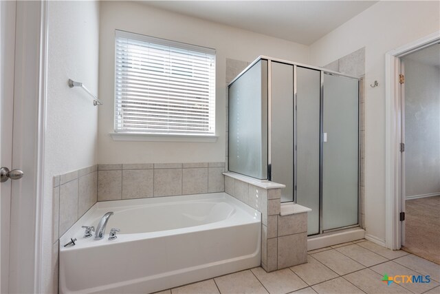 bathroom with tile patterned flooring and independent shower and bath