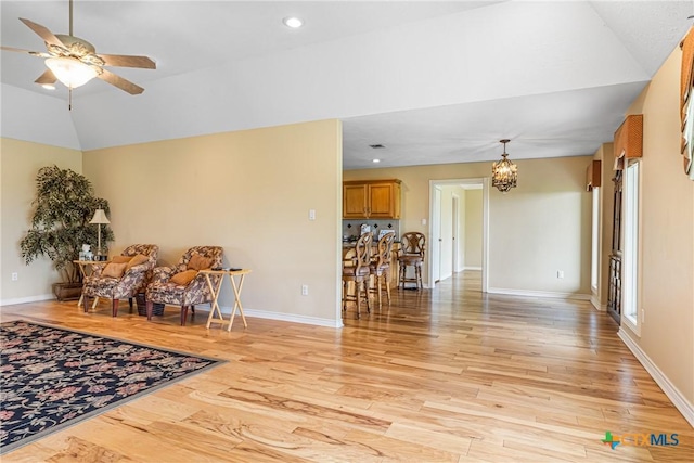 444 E Maxwell Ditch Rd, Port Lavaca, TX 77979 - living room with a ceiling fan, a chandelier, light wood-style flooring, vaulted ceiling, and plenty of natural light