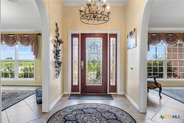 444 E Maxwell Ditch Rd, Port Lavaca, TX 77979 - foyer entrance with arched walkways, healthy amount of natural light, light tile patterned floors, and ornamental molding