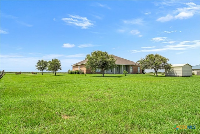 444 E Maxwell Ditch Rd, Port Lavaca, TX 77979 - view of grassy yard with a storage shed
