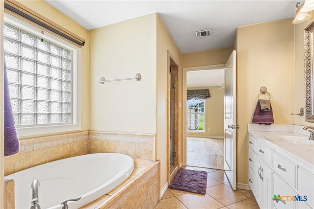 444 E Maxwell Ditch Rd, Port Lavaca, TX 77979 - bathroom featuring vanity, a garden tub, tile patterned floors, and a stall shower
