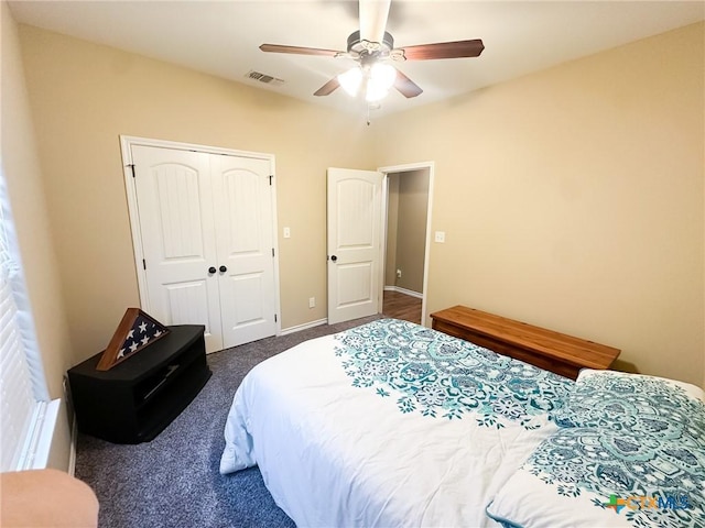 carpeted bedroom featuring ceiling fan and a closet