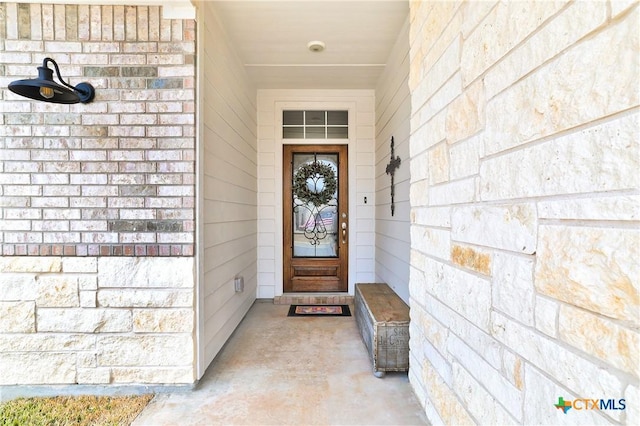 entrance to property featuring brick siding