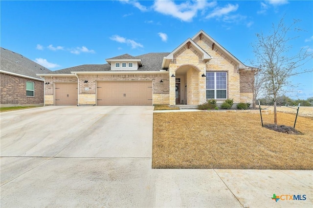 view of front of house with brick siding, a shingled roof, a garage, stone siding, and driveway