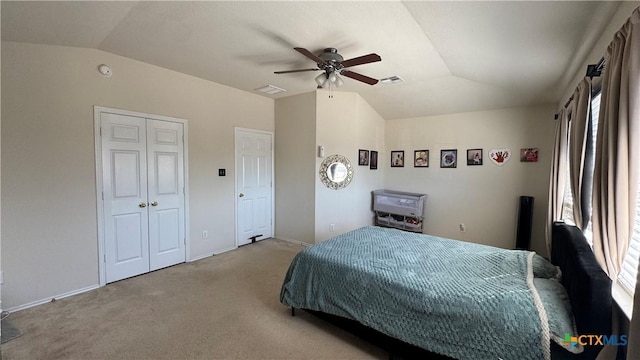 bedroom featuring lofted ceiling, multiple windows, visible vents, and light colored carpet