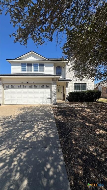 traditional home featuring driveway and a garage