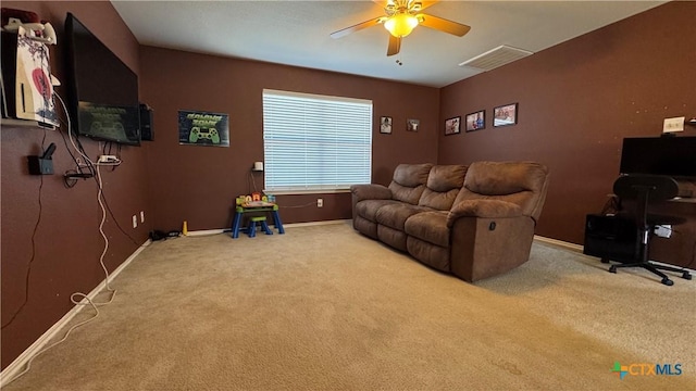 interior space with light carpet, baseboards, visible vents, and a ceiling fan