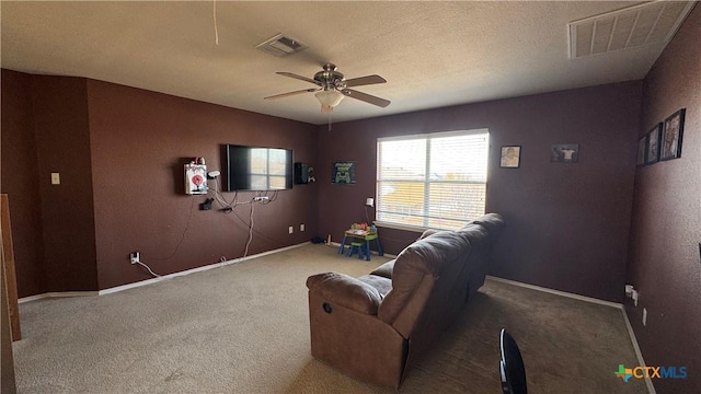 interior space featuring carpet floors, ceiling fan, visible vents, and a textured ceiling