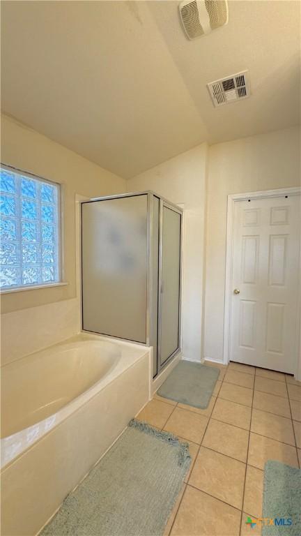 bathroom with a garden tub, a shower stall, visible vents, and tile patterned floors