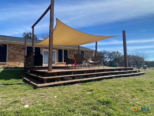 953 County Road 3351, Kempner, TX 76539 - rear view of property featuring brick siding, a deck, and a yard