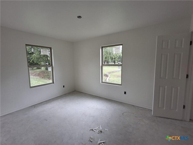 1617 E Miller St, Belton, TX 76513 - spare room featuring concrete floors and baseboards