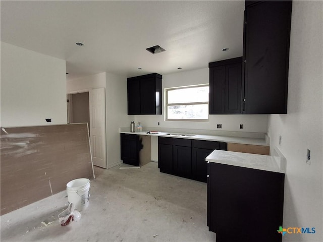 1617 E Miller St, Belton, TX 76513 - kitchen featuring dark cabinets and concrete floors