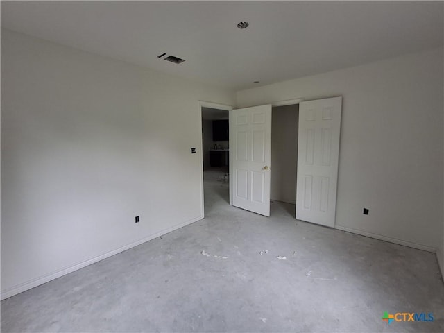 1617 E Miller St, Belton, TX 76513 - unfurnished bedroom featuring unfinished concrete floors and baseboards