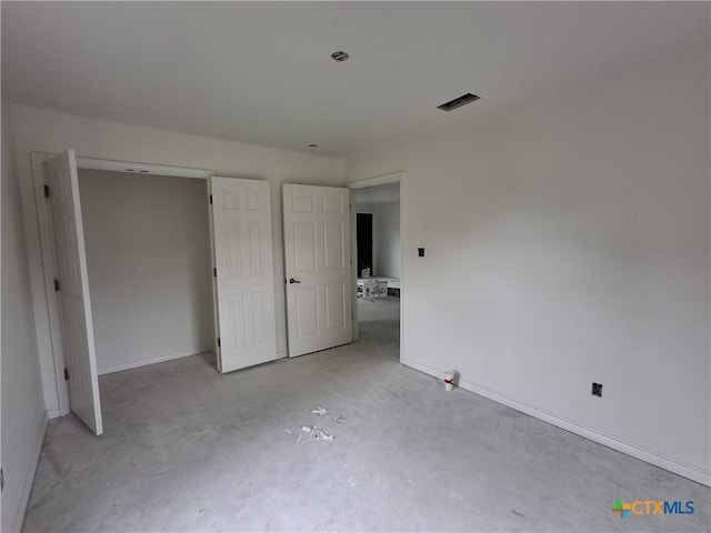 1617 E Miller St, Belton, TX 76513 - unfurnished bedroom featuring unfinished concrete floors and baseboards