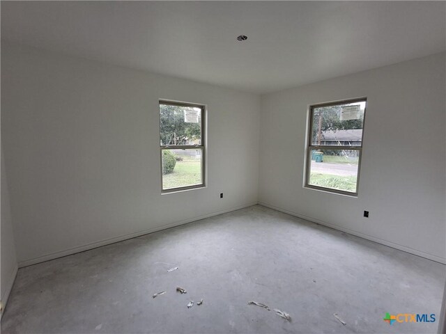 1617 E Miller St, Belton, TX 76513 - empty room with concrete floors and baseboards