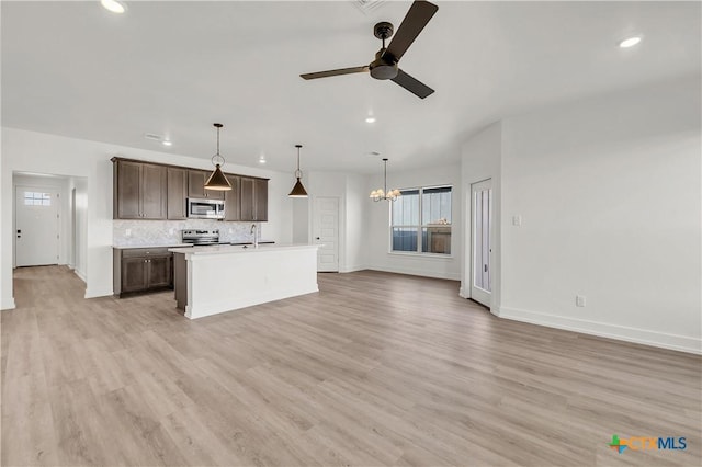 2318 Healy Dr, Temple, TX 76502 - kitchen with stainless steel appliances, a ceiling fan, dark brown cabinetry, recessed lighting, and open floor plan