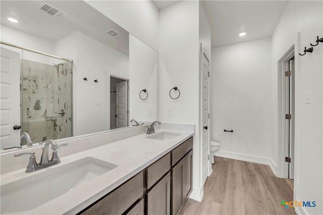 2318 Healy Dr, Temple, TX 76502 - full bath featuring toilet, a marble finish shower, wood finished floors, double vanity, and recessed lighting