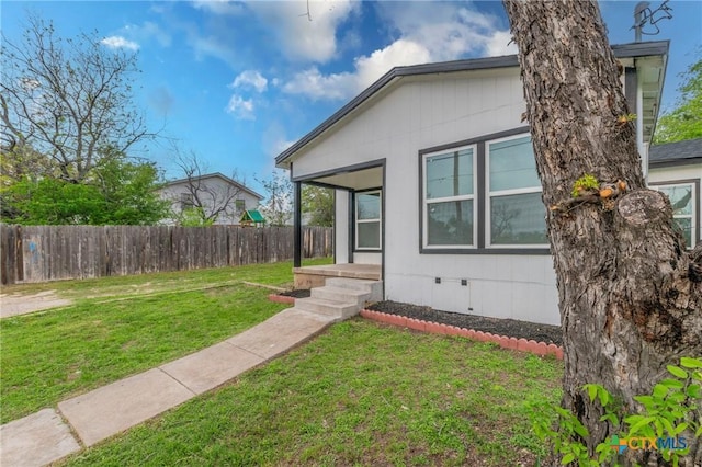 exterior space with fence, crawl space, and a yard